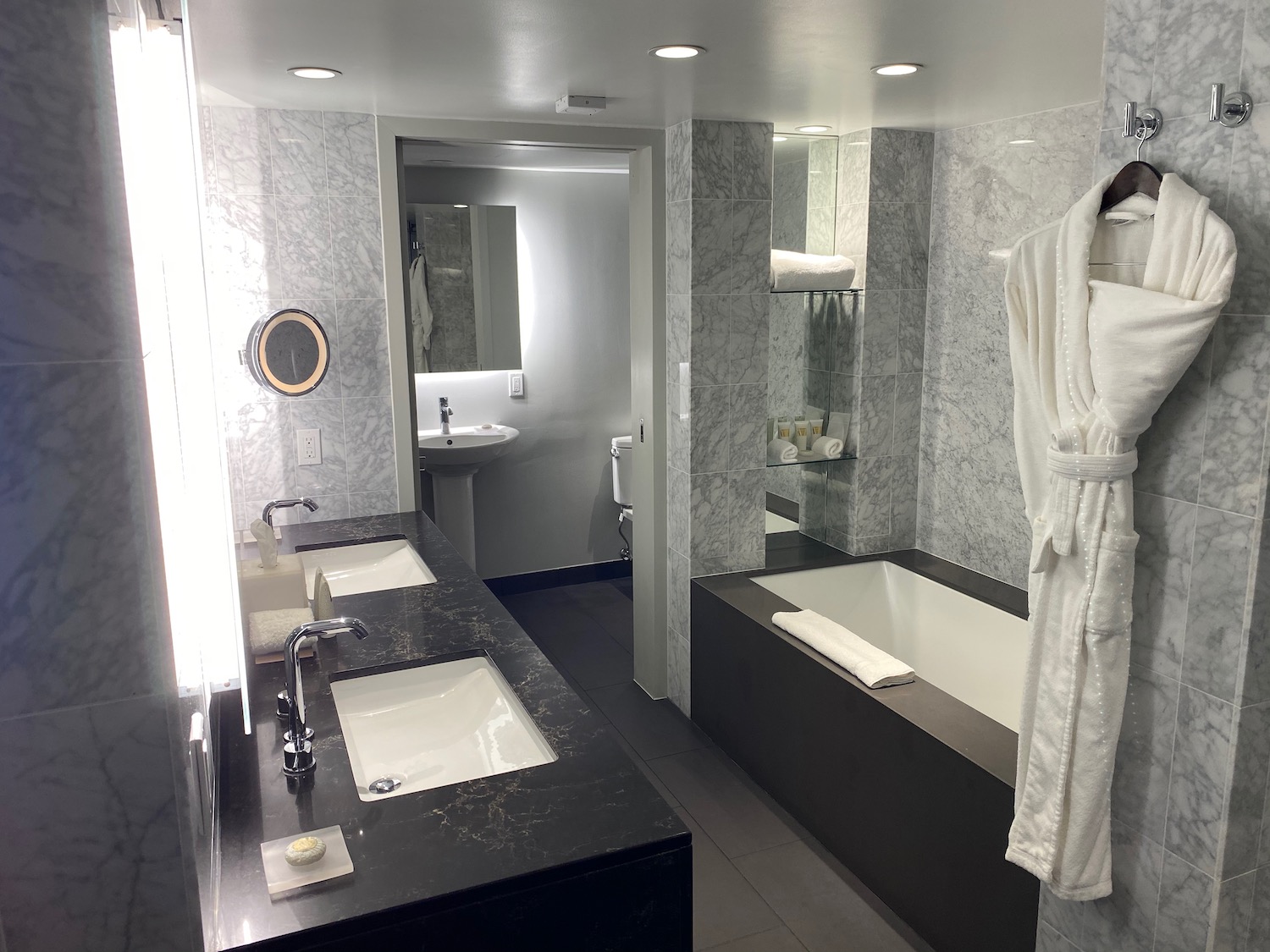 a bathroom with marble walls and a bathtub