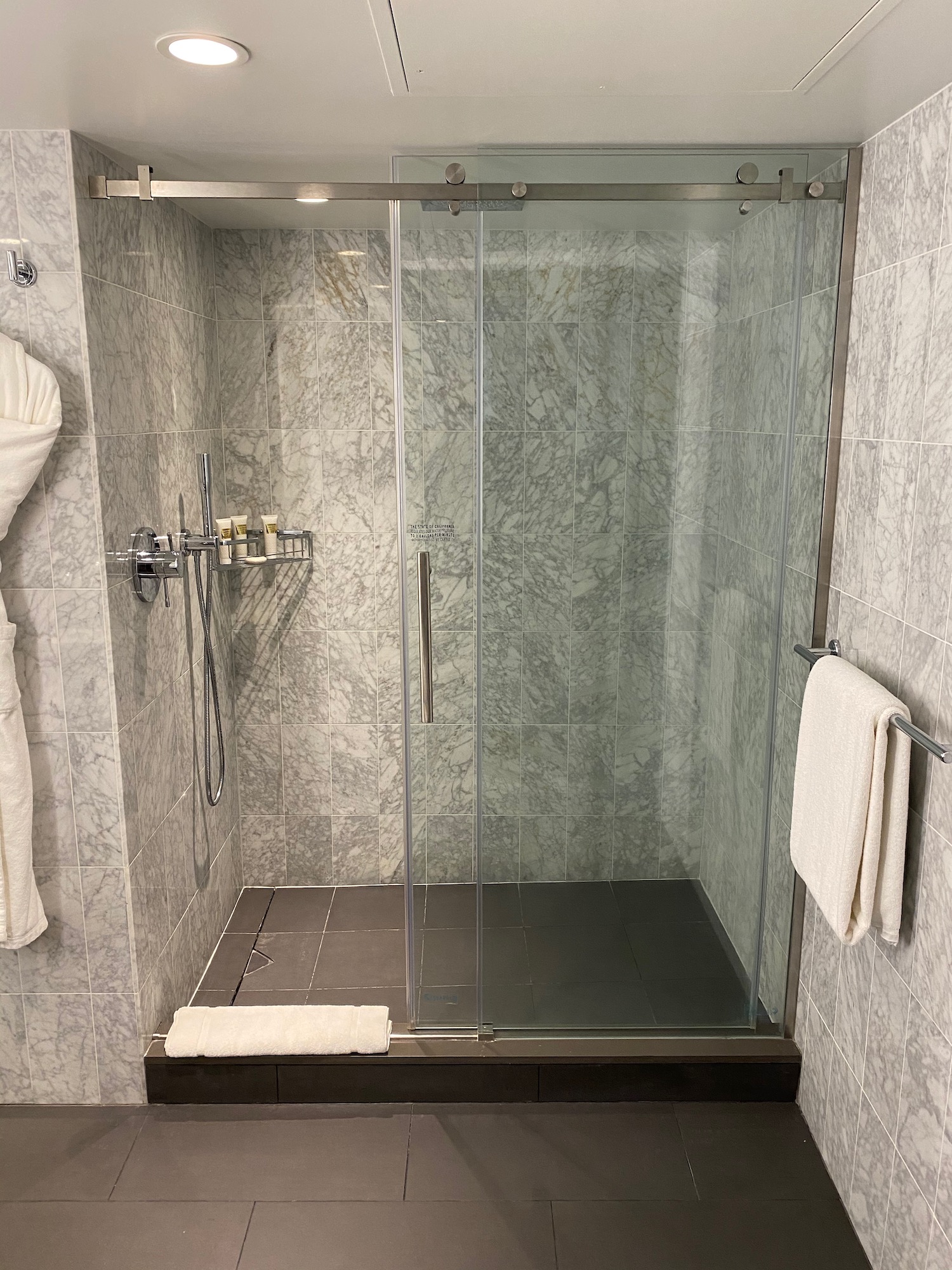 a glass shower with a stand up shower