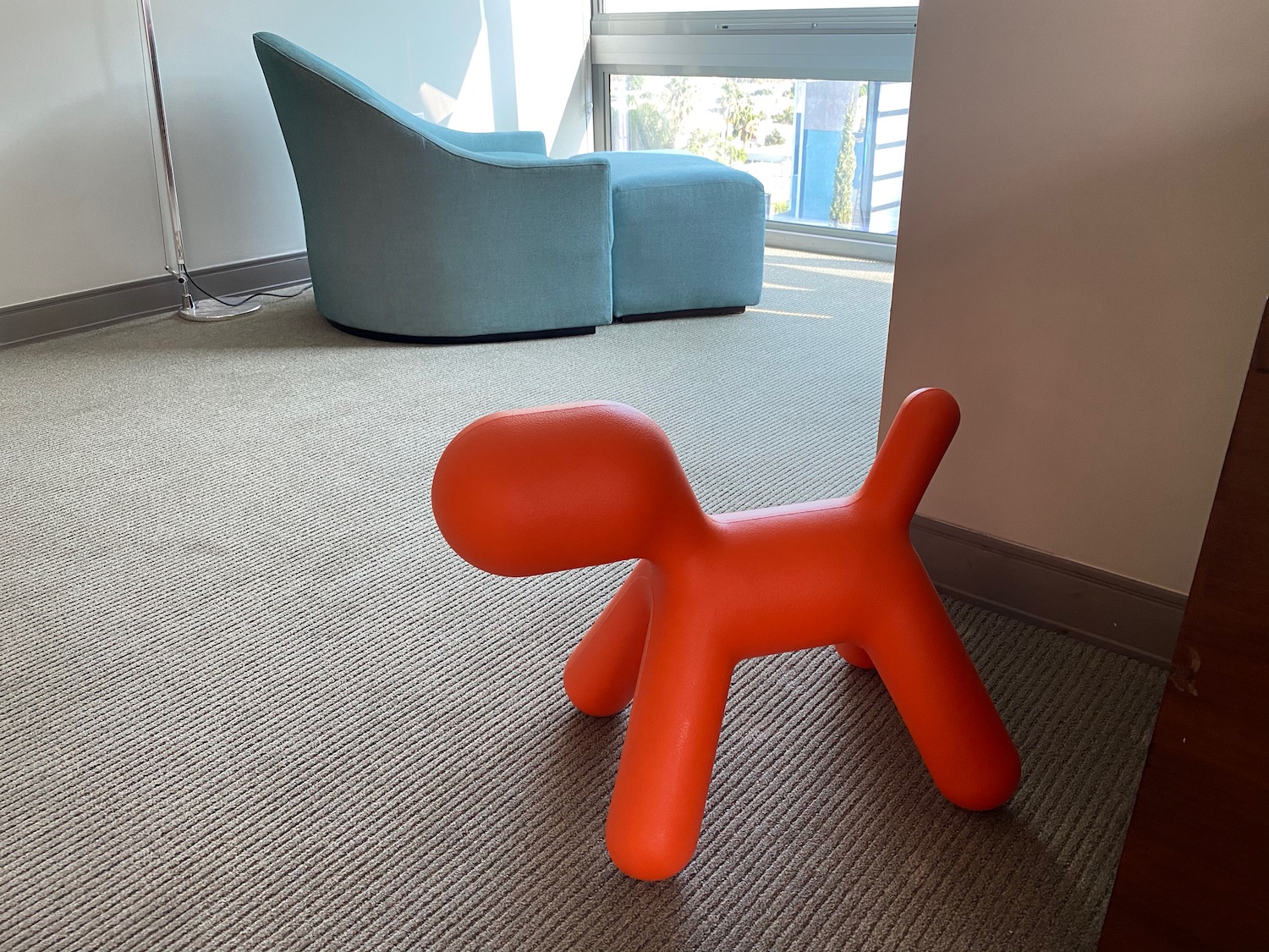 a red balloon dog on carpet