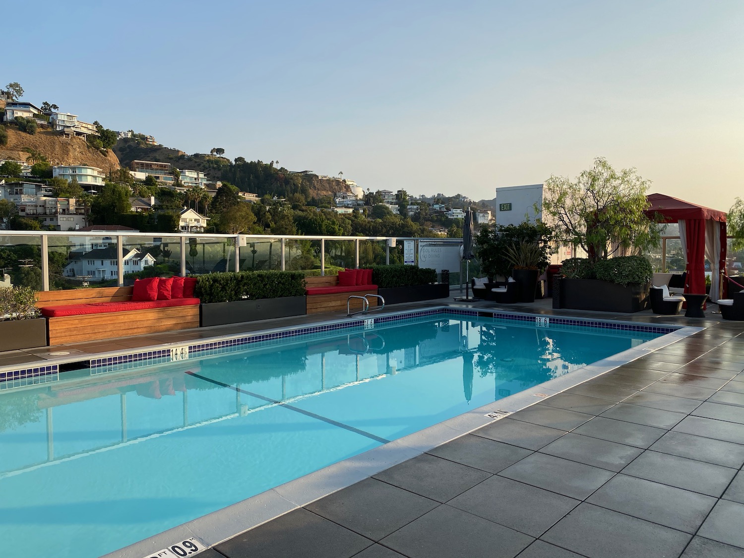 a pool with a fence and a building in the background