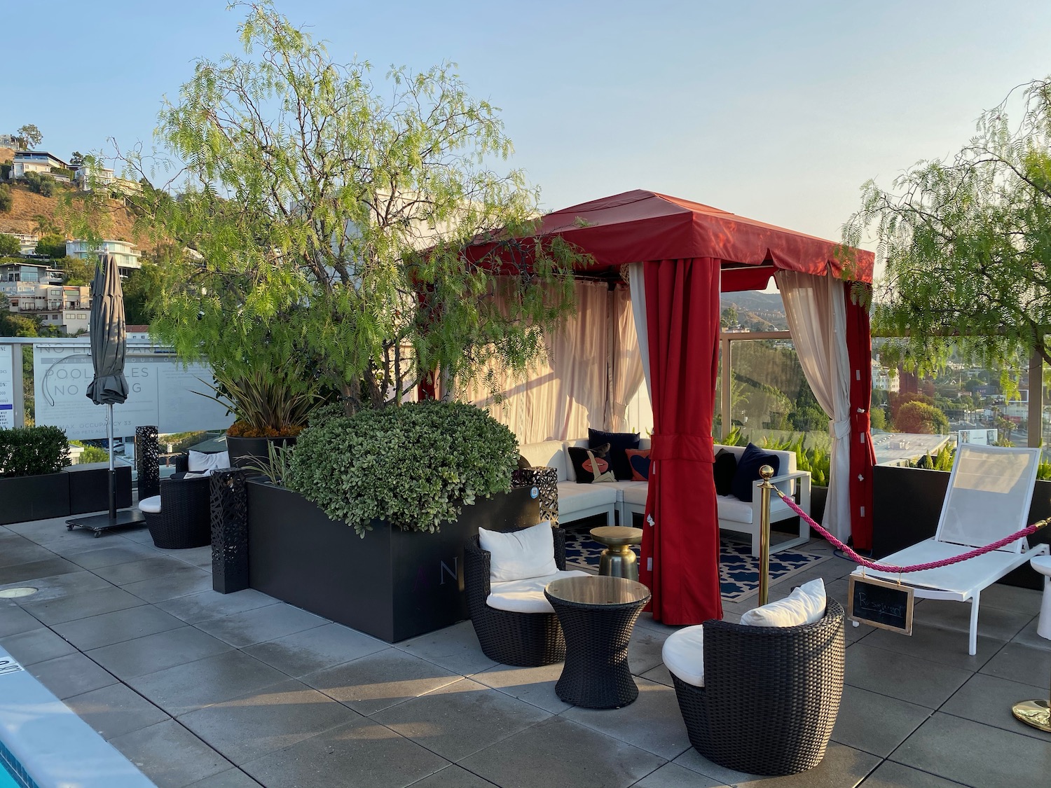 a patio with a red and white canopy and chairs