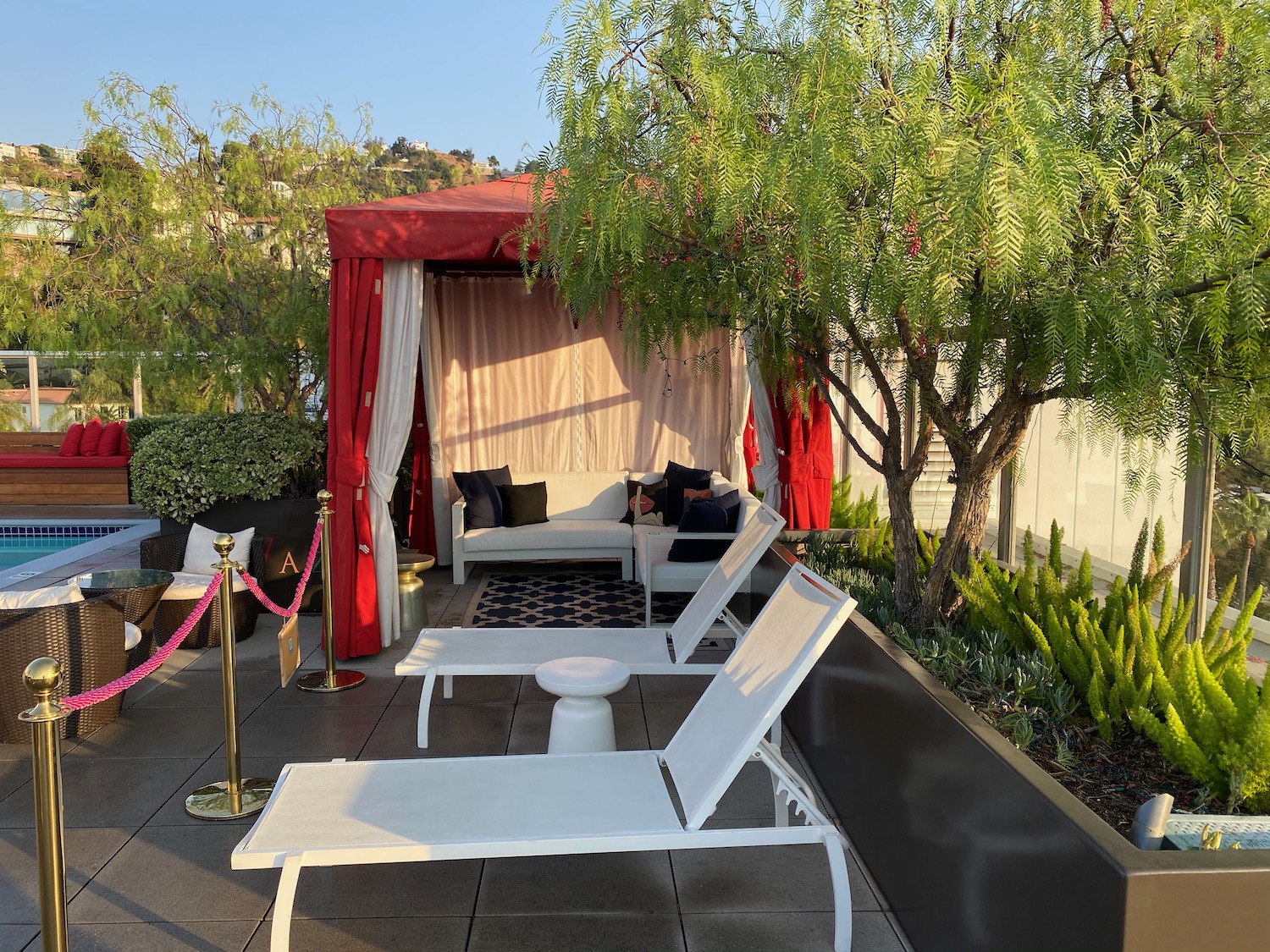 a patio with chairs and a red canopy