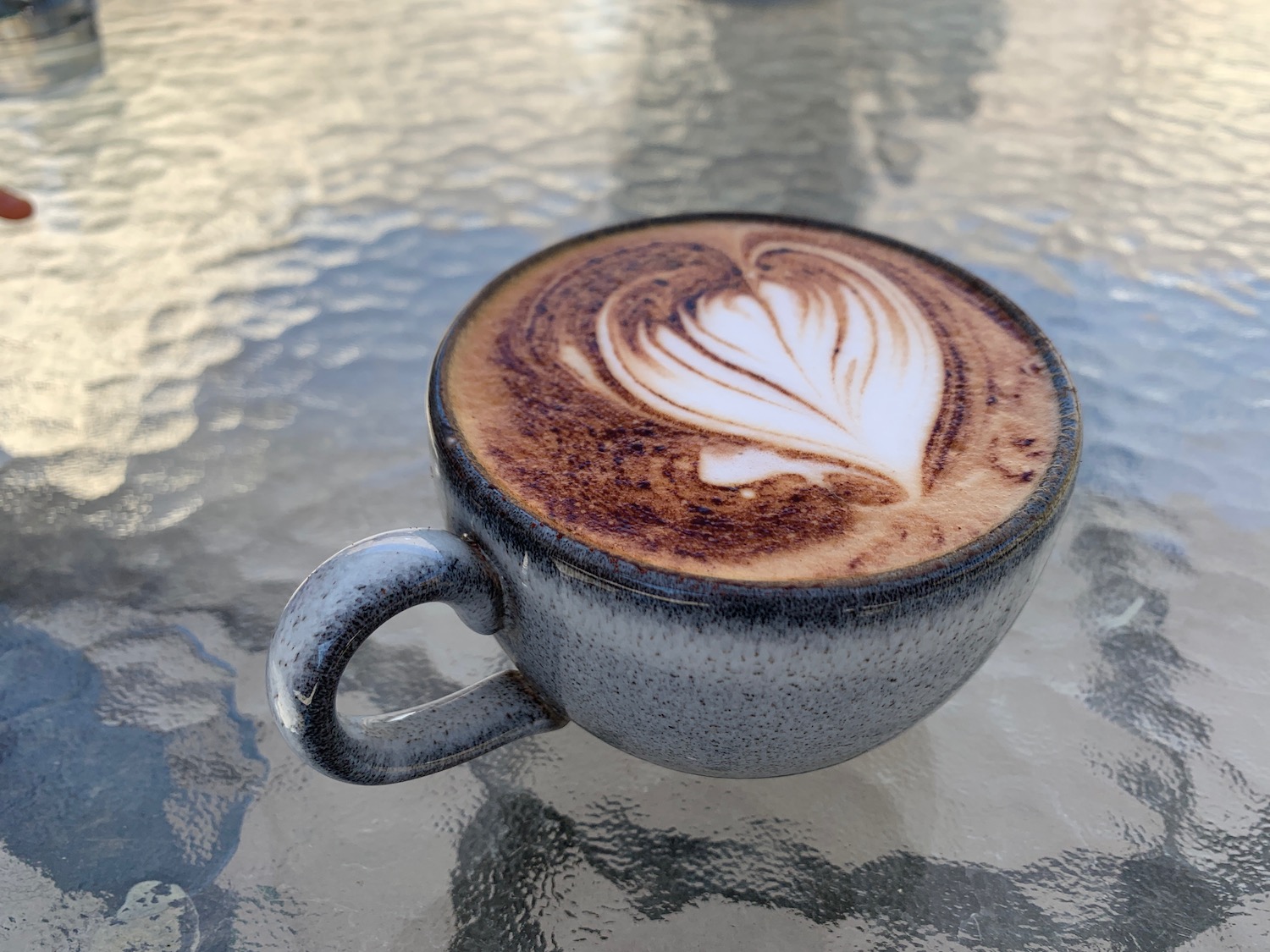 a cup of coffee with a heart design in it