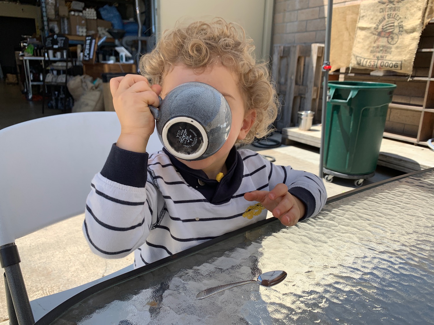 a child drinking from a tea cup