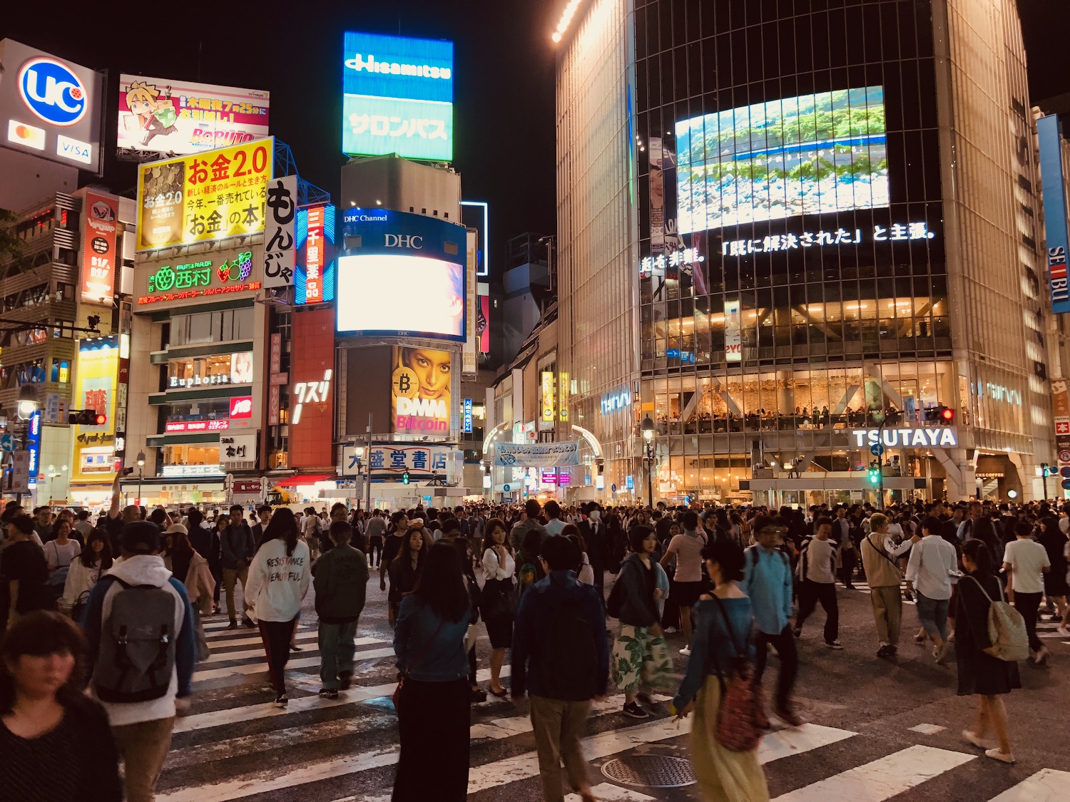 a crowd of people crossing a street