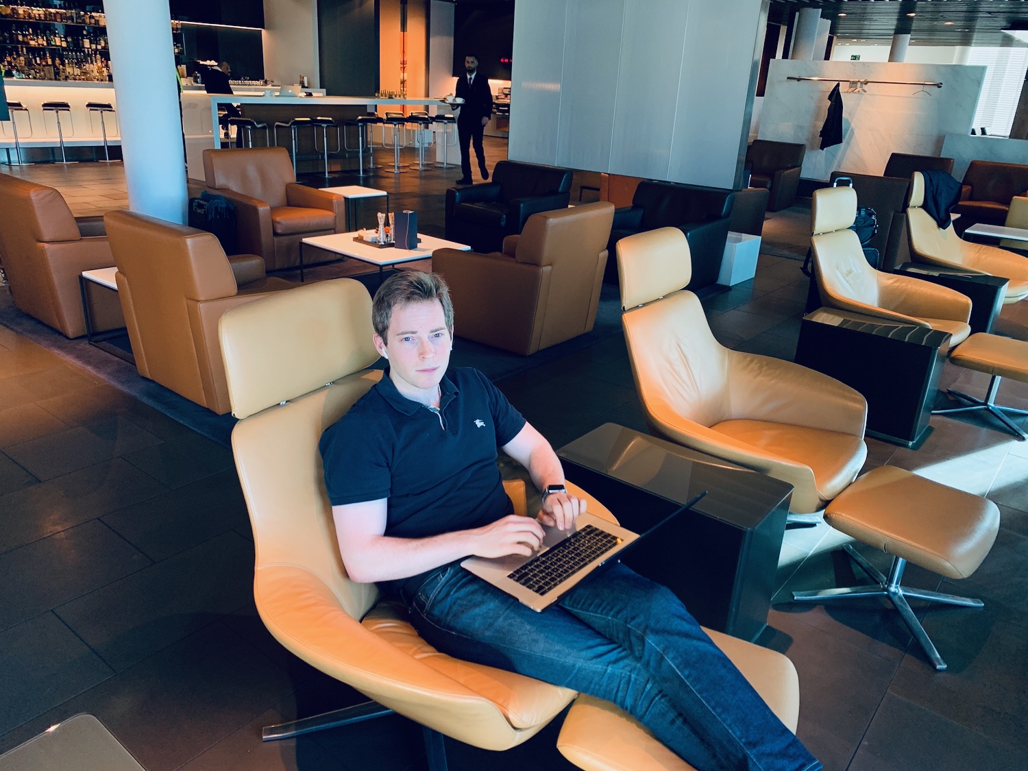 a man sitting in a chair with a laptop