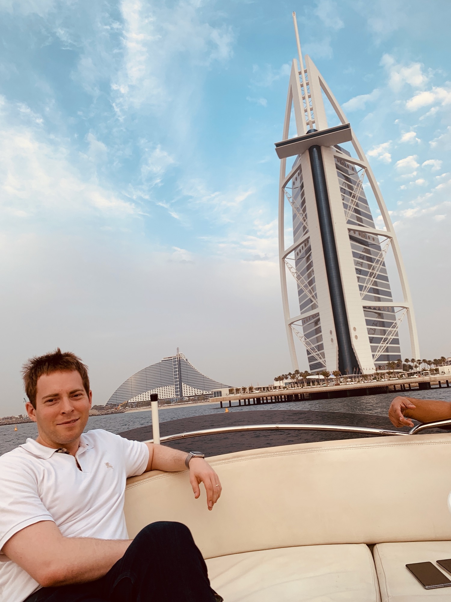 a man sitting on a boat in front of a tall building