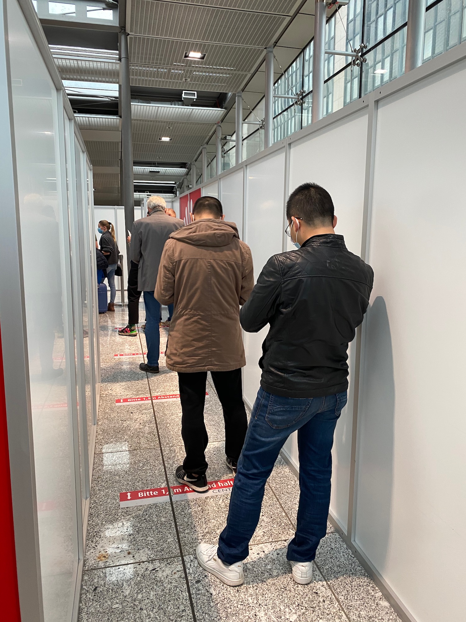 a group of people standing in a hallway