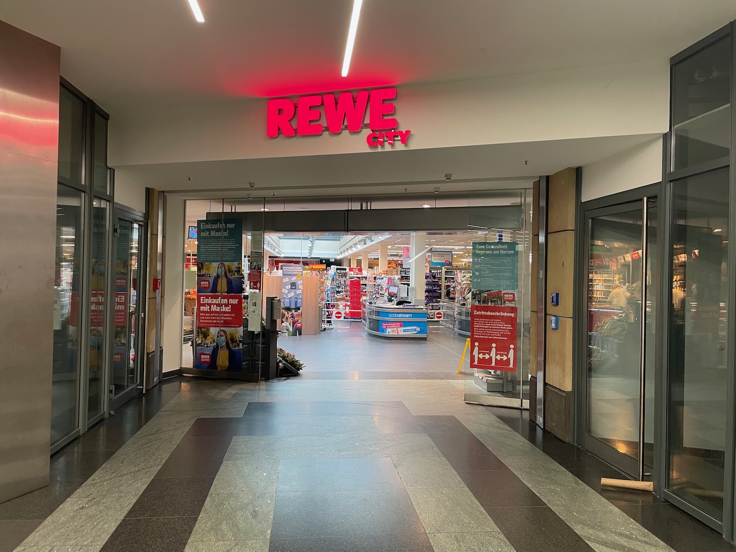 a store entrance with red sign