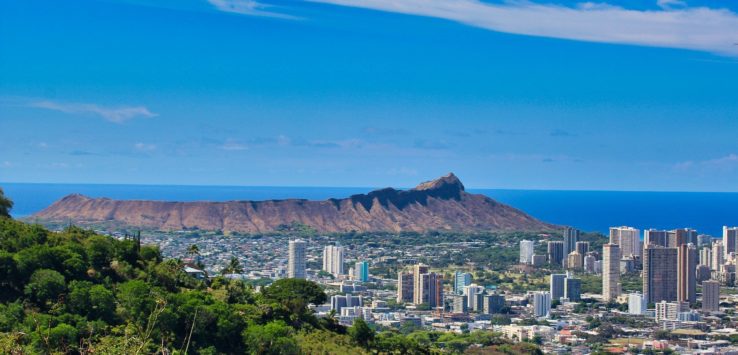 a cityscape with a mountain in the background