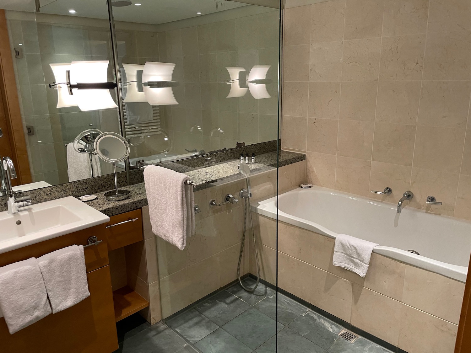 a bathroom with a glass shower door and tub