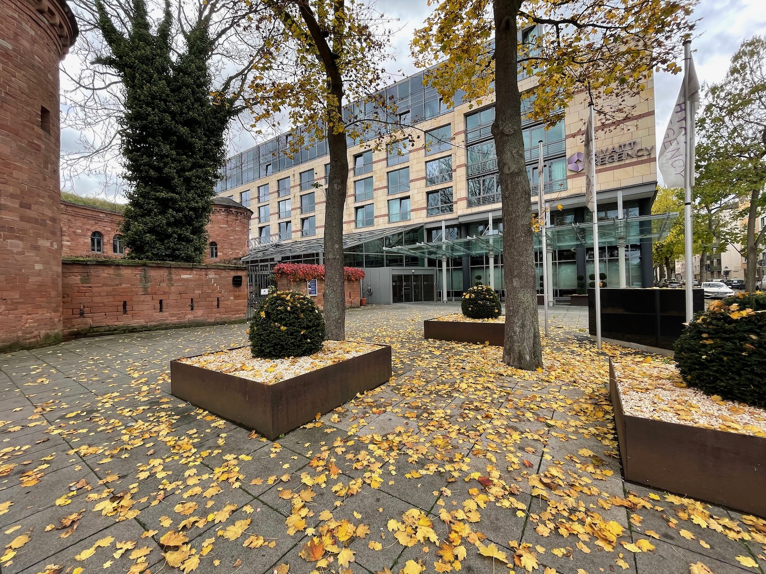 a building with trees and leaves on the ground