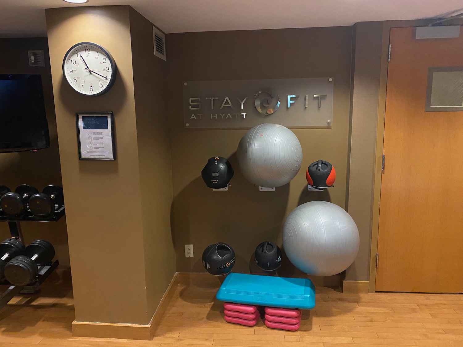 a wall with balls and a sign on it