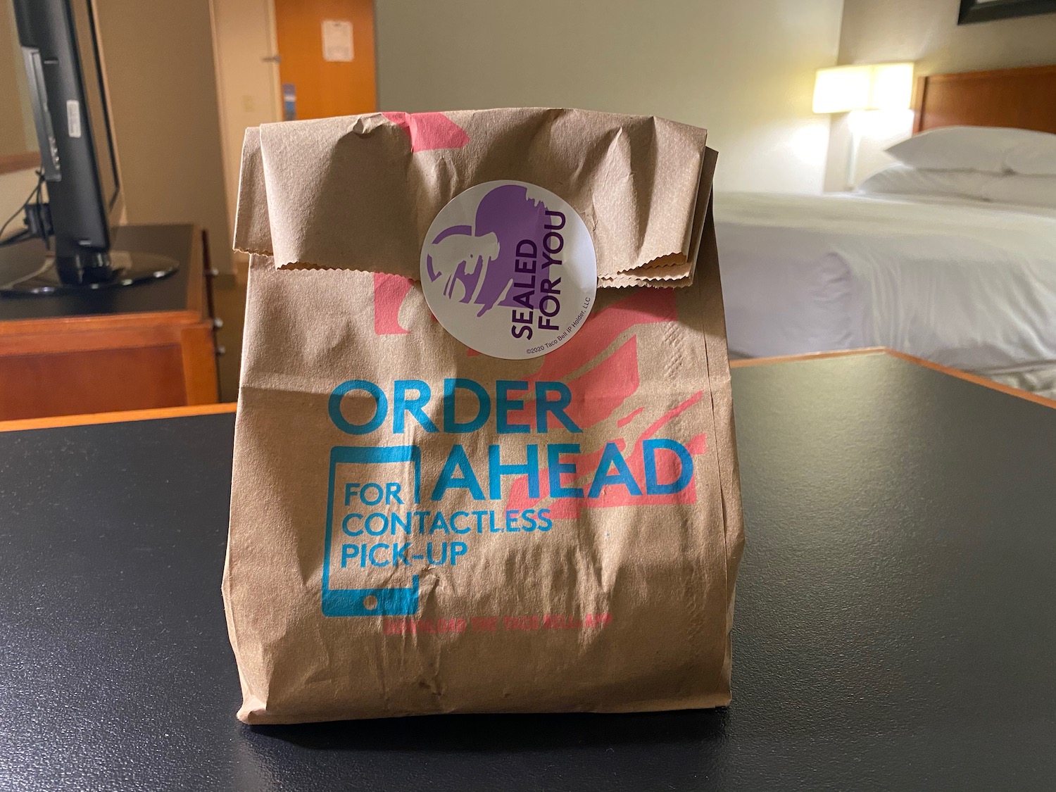 a brown paper bag with blue and red text on it