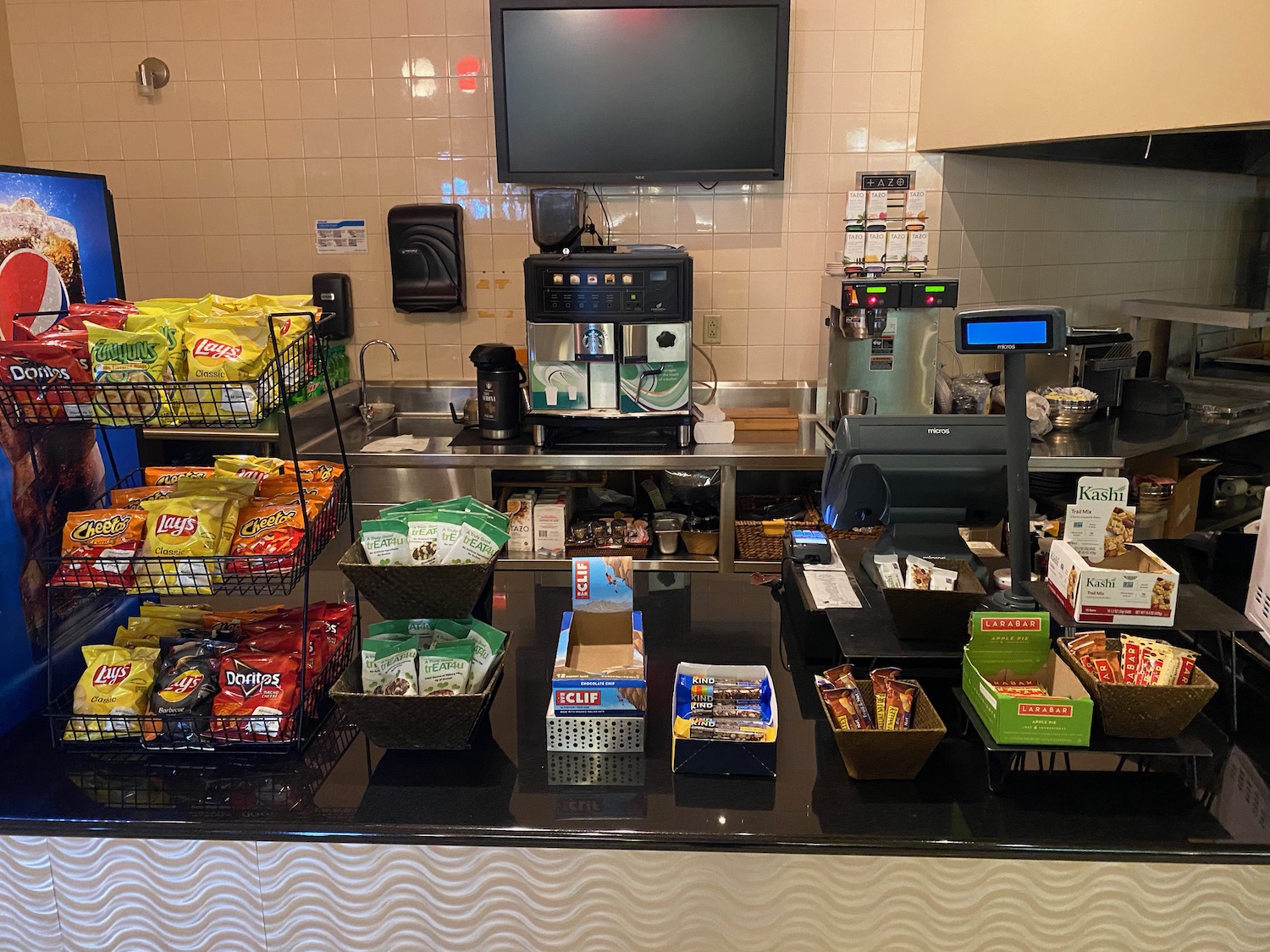 a counter with a variety of snacks and a tv