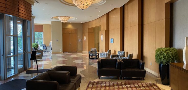 a lobby with chairs and a rug