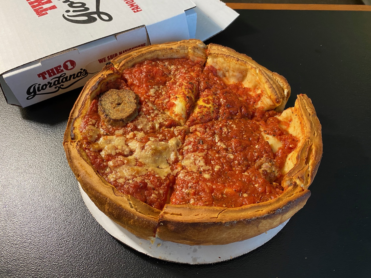 a deep dish pizza with a slice of pizza in it