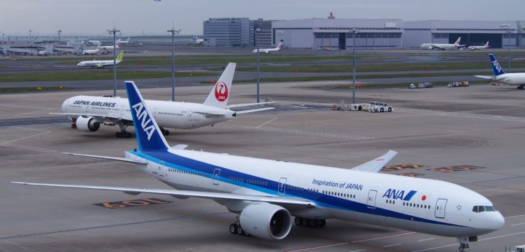 a group of airplanes on a runway