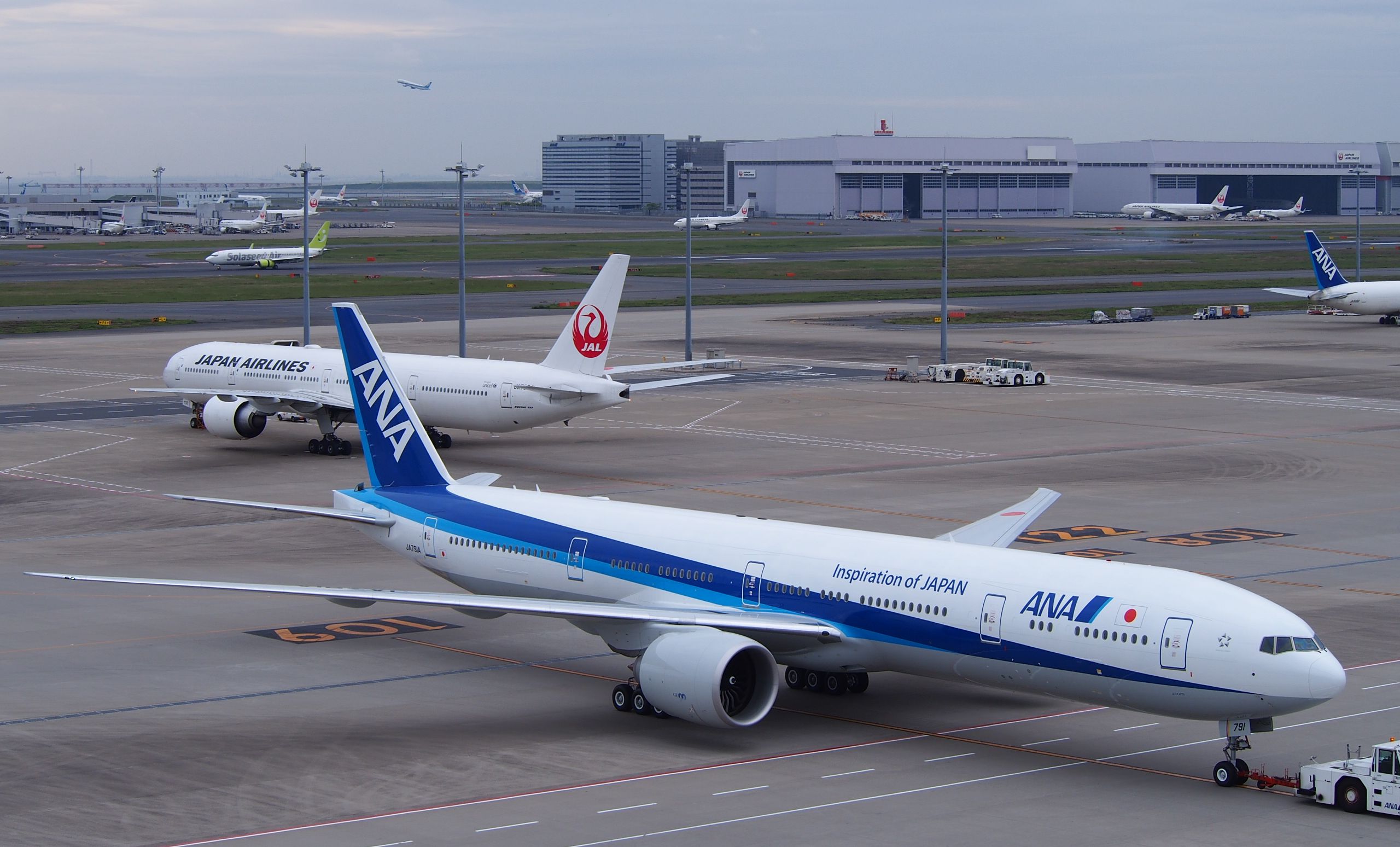 a group of airplanes on a runway