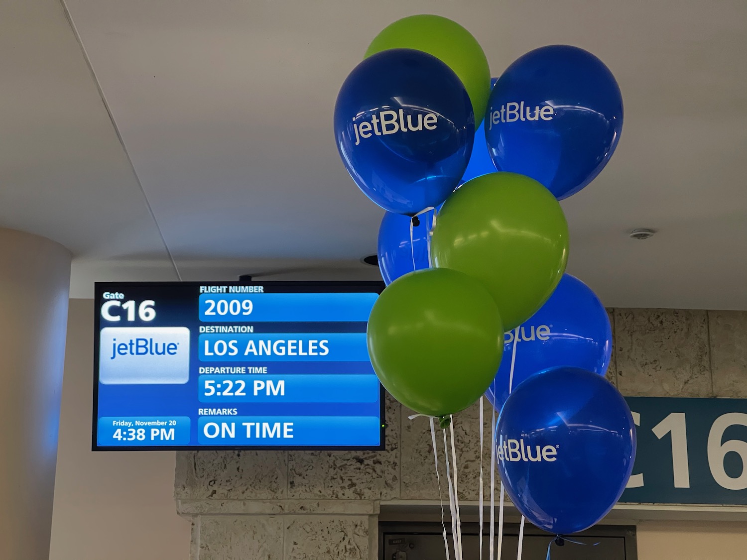 a bunch of balloons in front of a sign