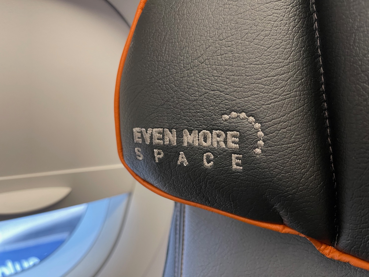 a black and orange leather seat with text on it