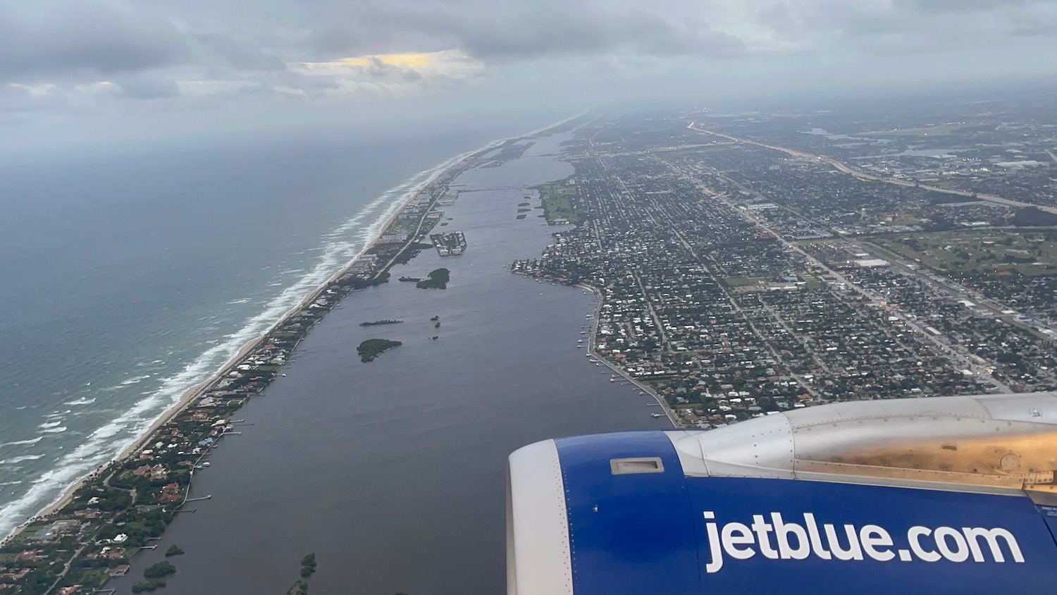 an airplane wing and a body of water