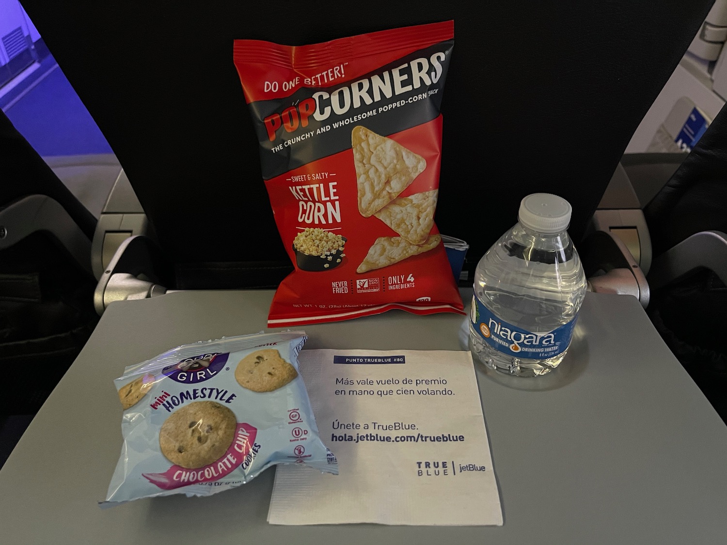 a bag of chips and a bottle of water on a table