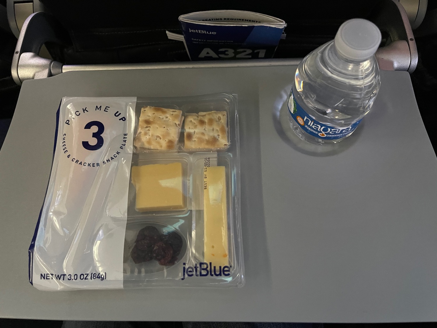 a bottle of water and crackers on a table