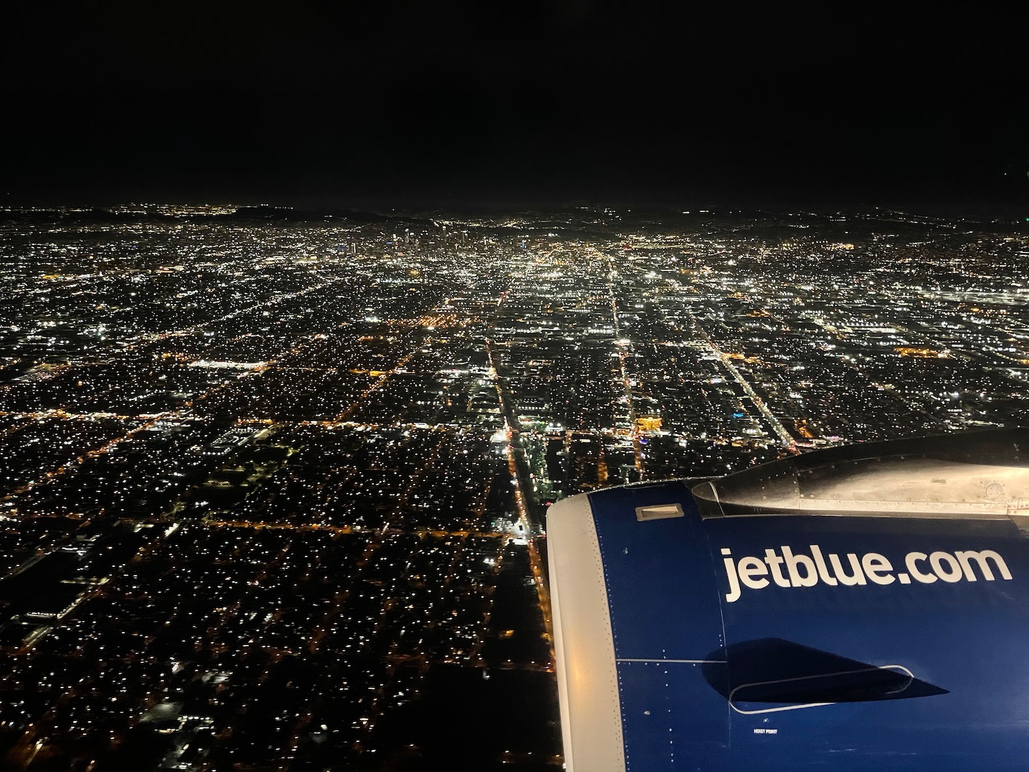 an airplane wing and a city at night