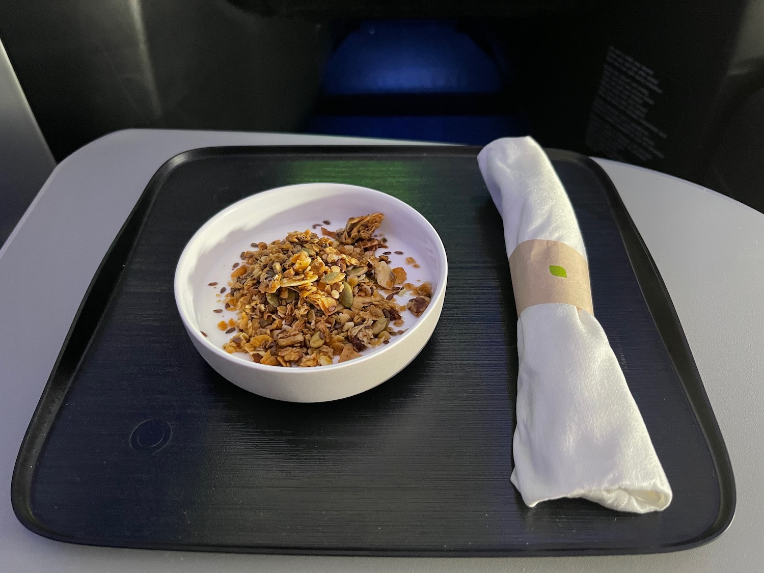 a bowl of cereal and a napkin on a tray