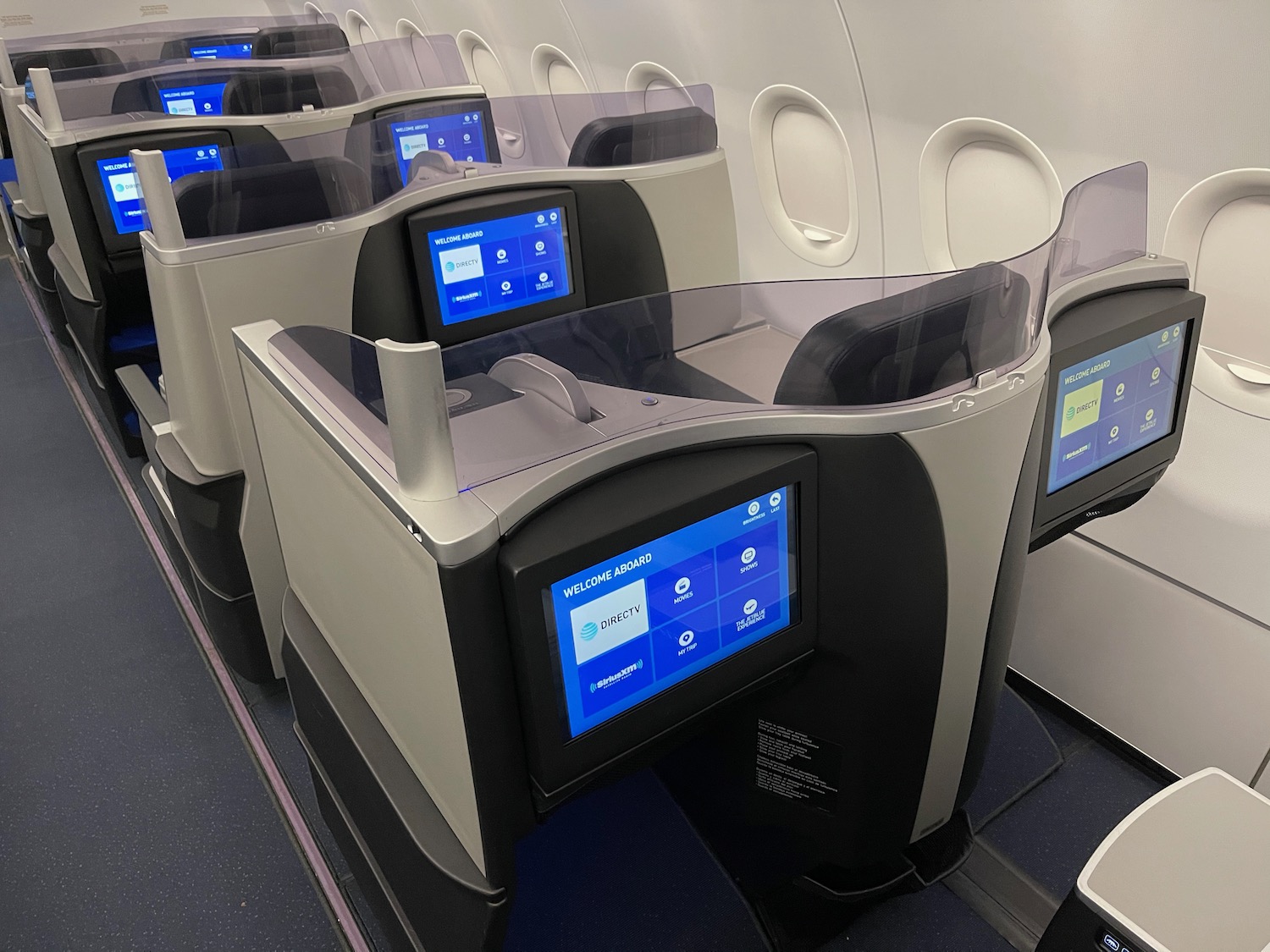 a row of seats with screens on the side