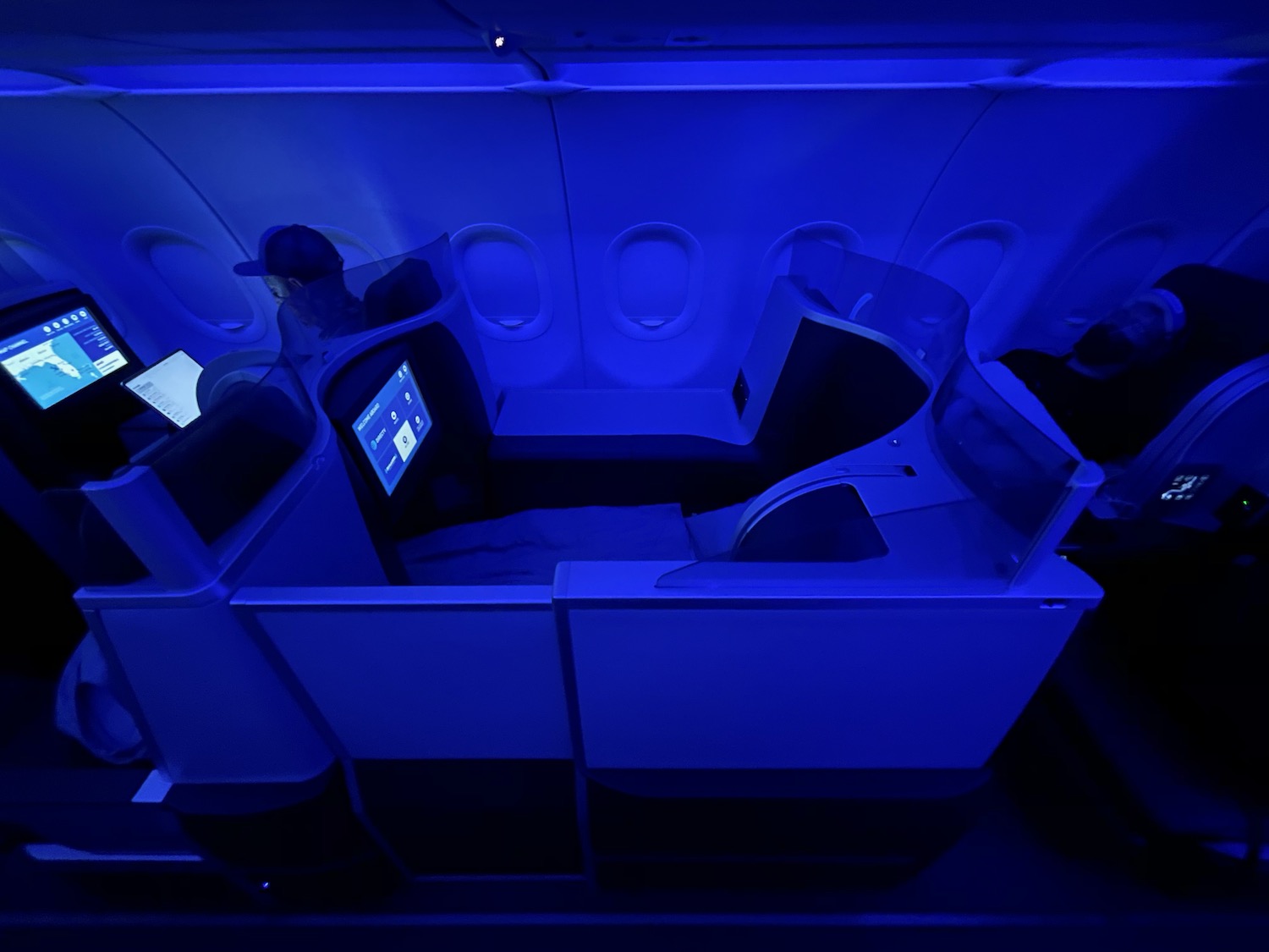 a person sitting in a chair in a blue lit room