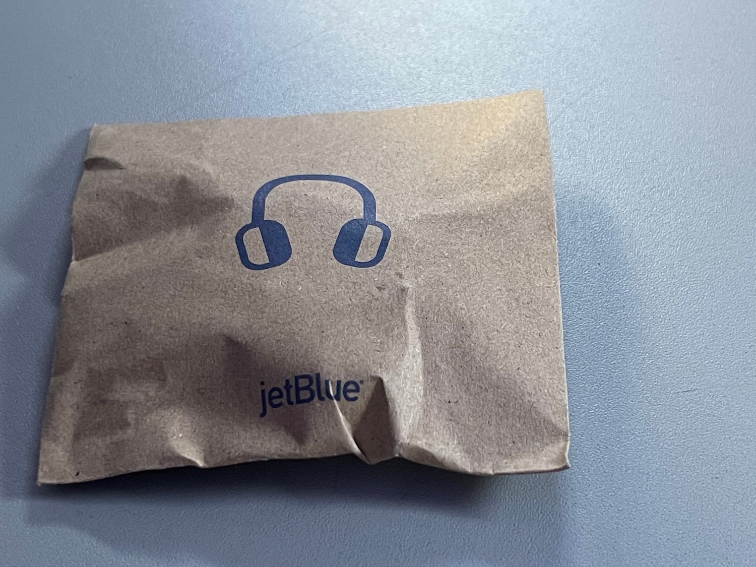 a brown paper bag with headphones on it