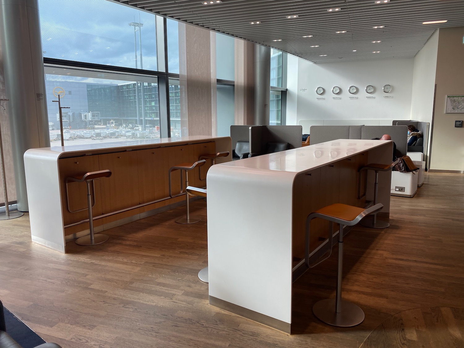 a room with a long white counter and chairs