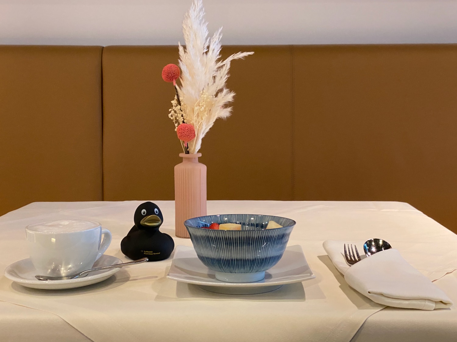 a table with a bowl and a vase of flowers