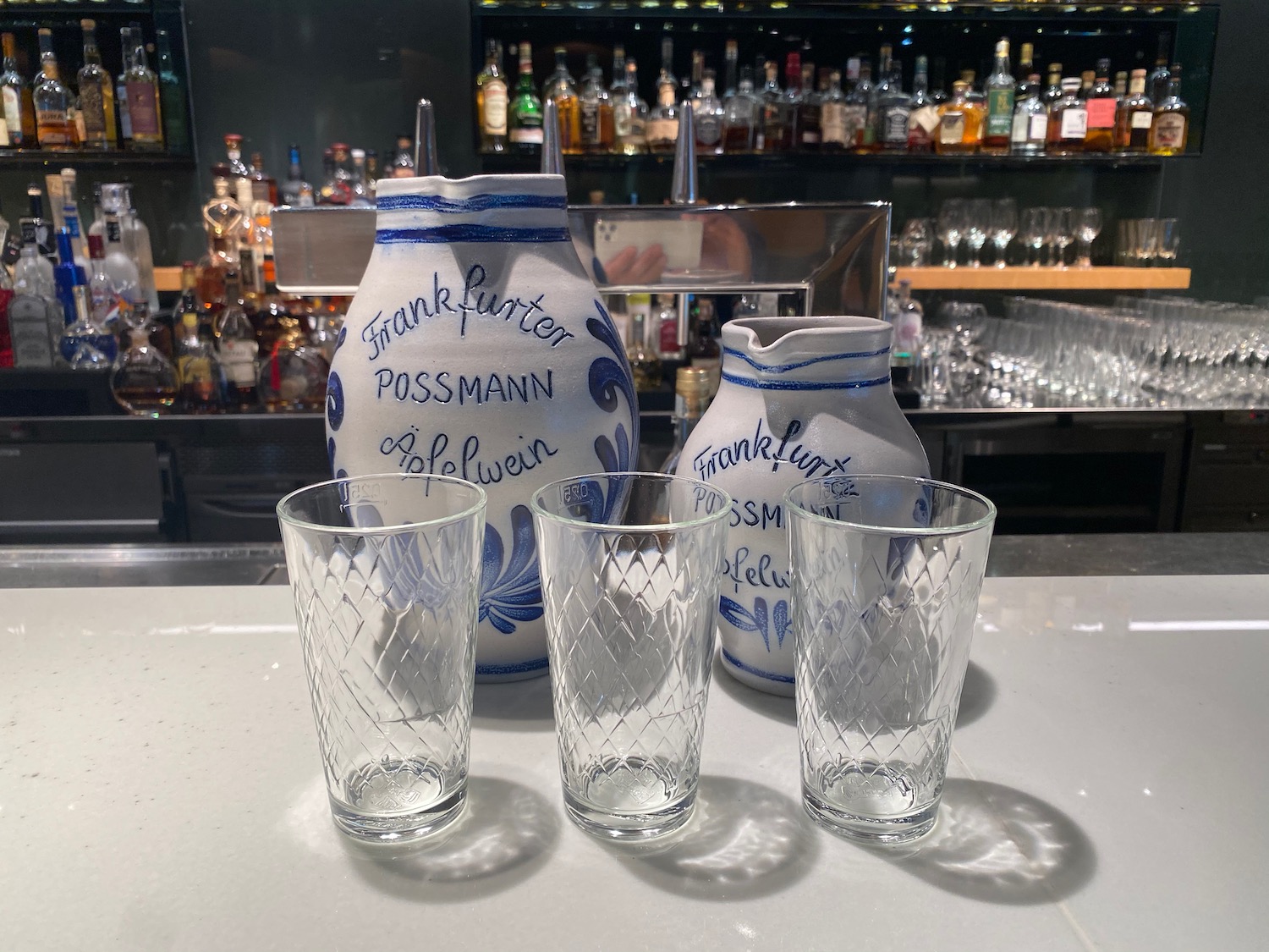 a group of glasses and pitcher on a table