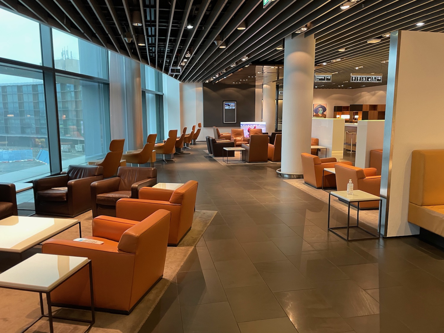 a room with brown chairs and tables