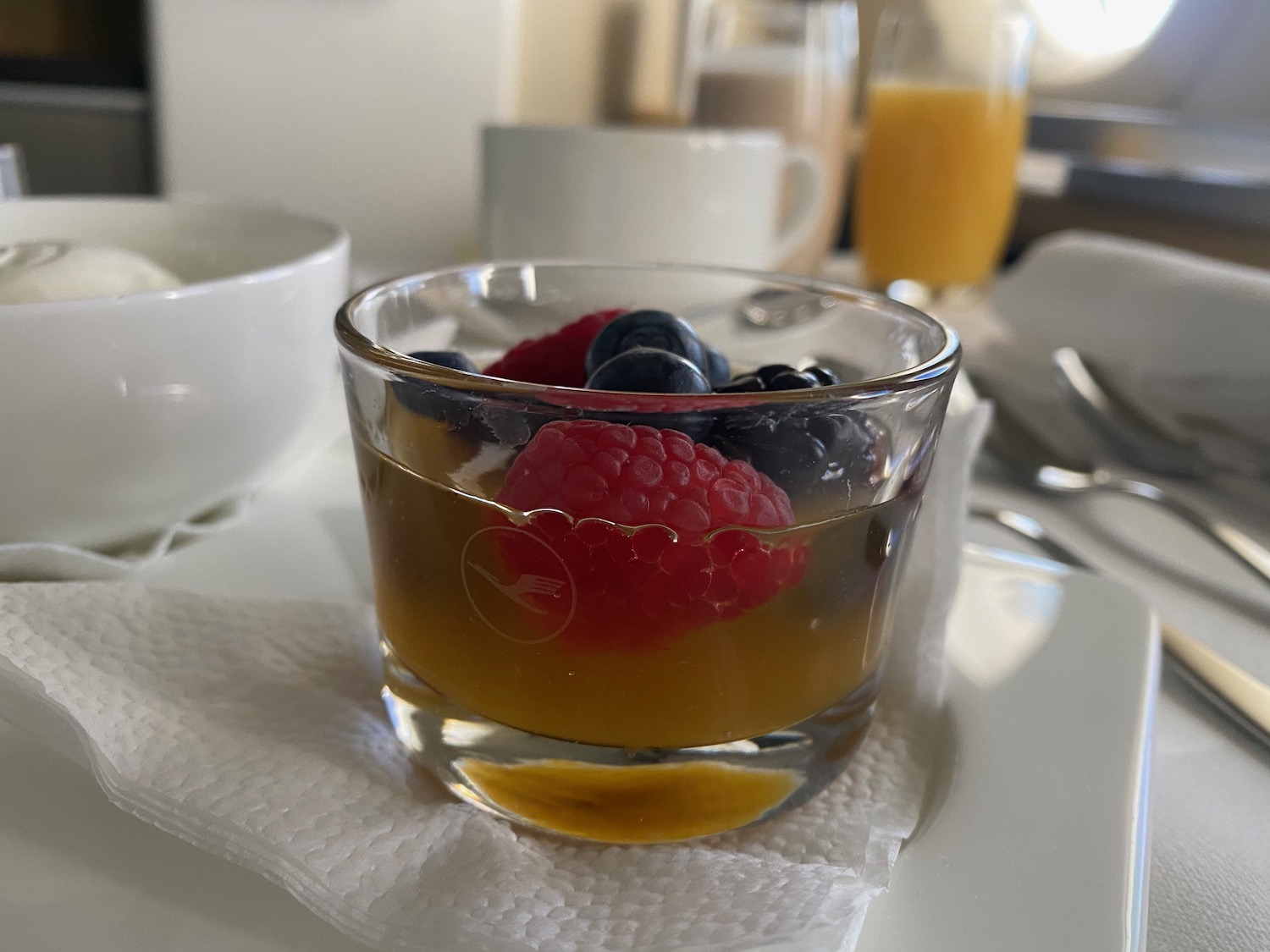 a glass of fruit on a napkin