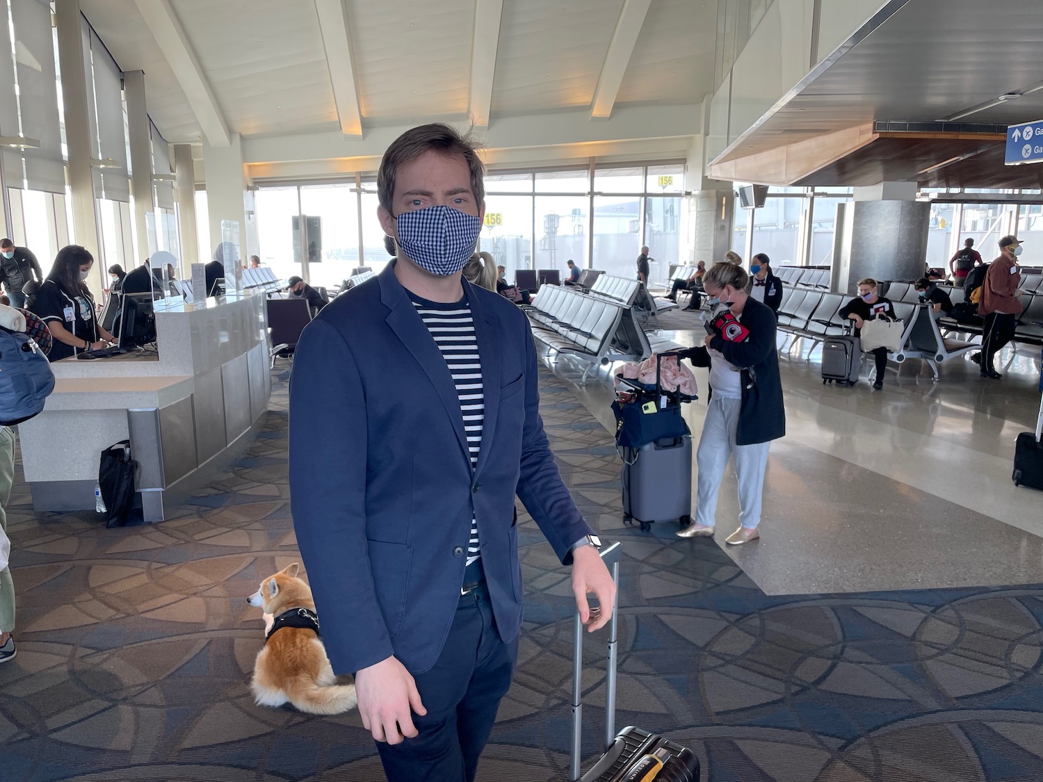 a man wearing a mask in an airport