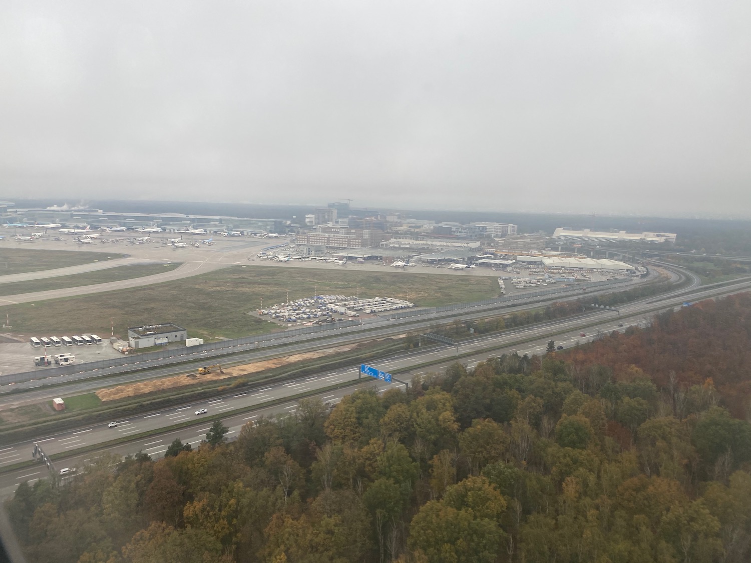 an aerial view of a highway with trees and buildings