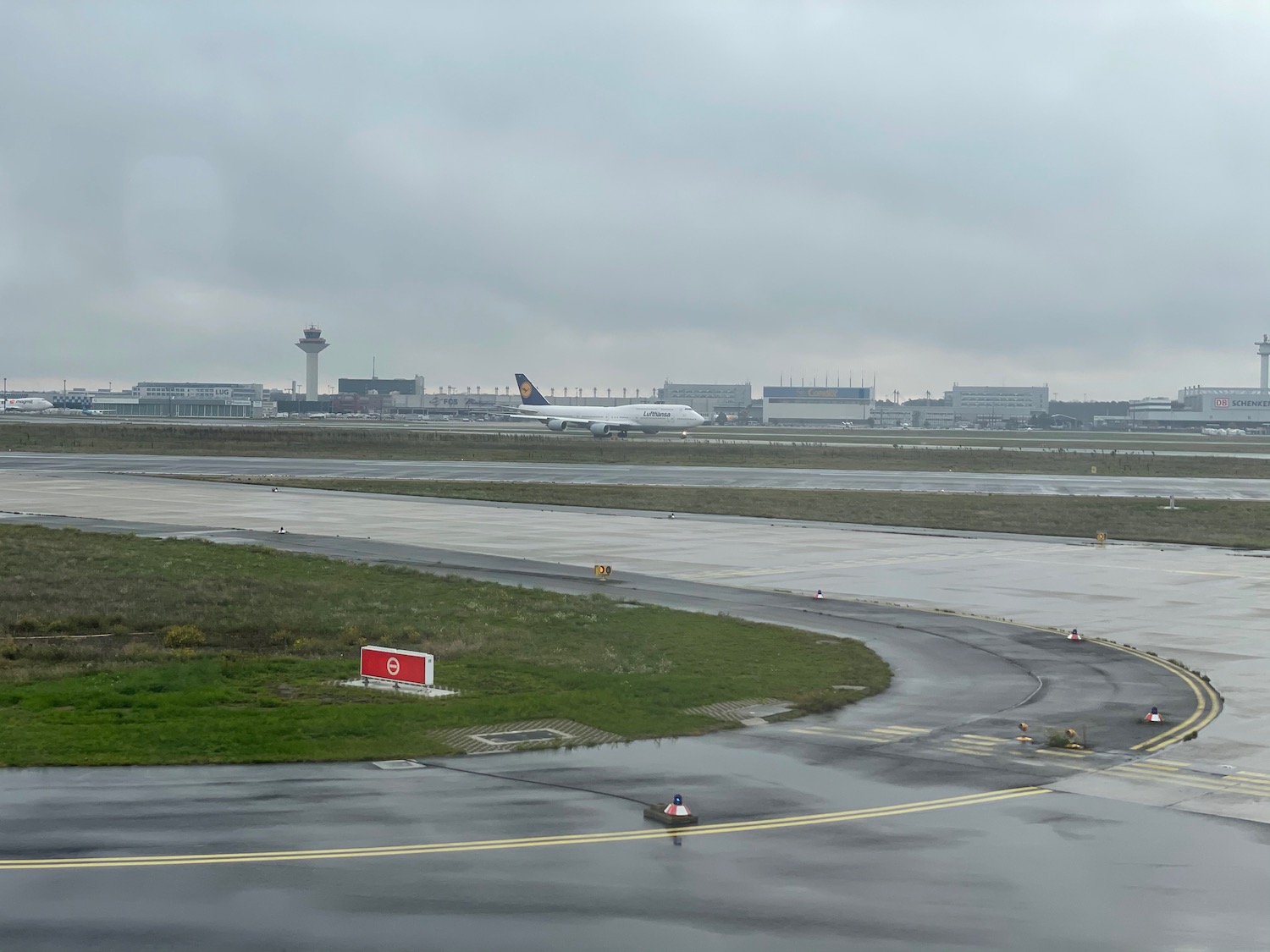 an airport runway with a plane in the background