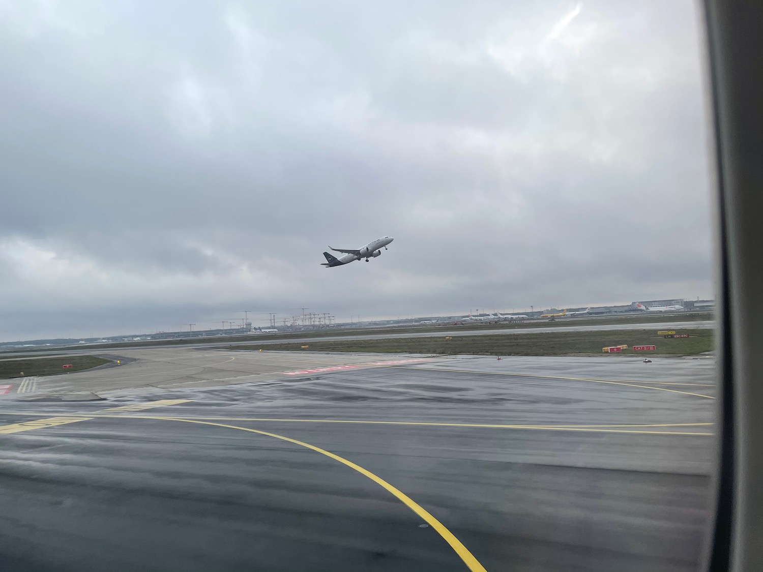 an airplane flying over a runway