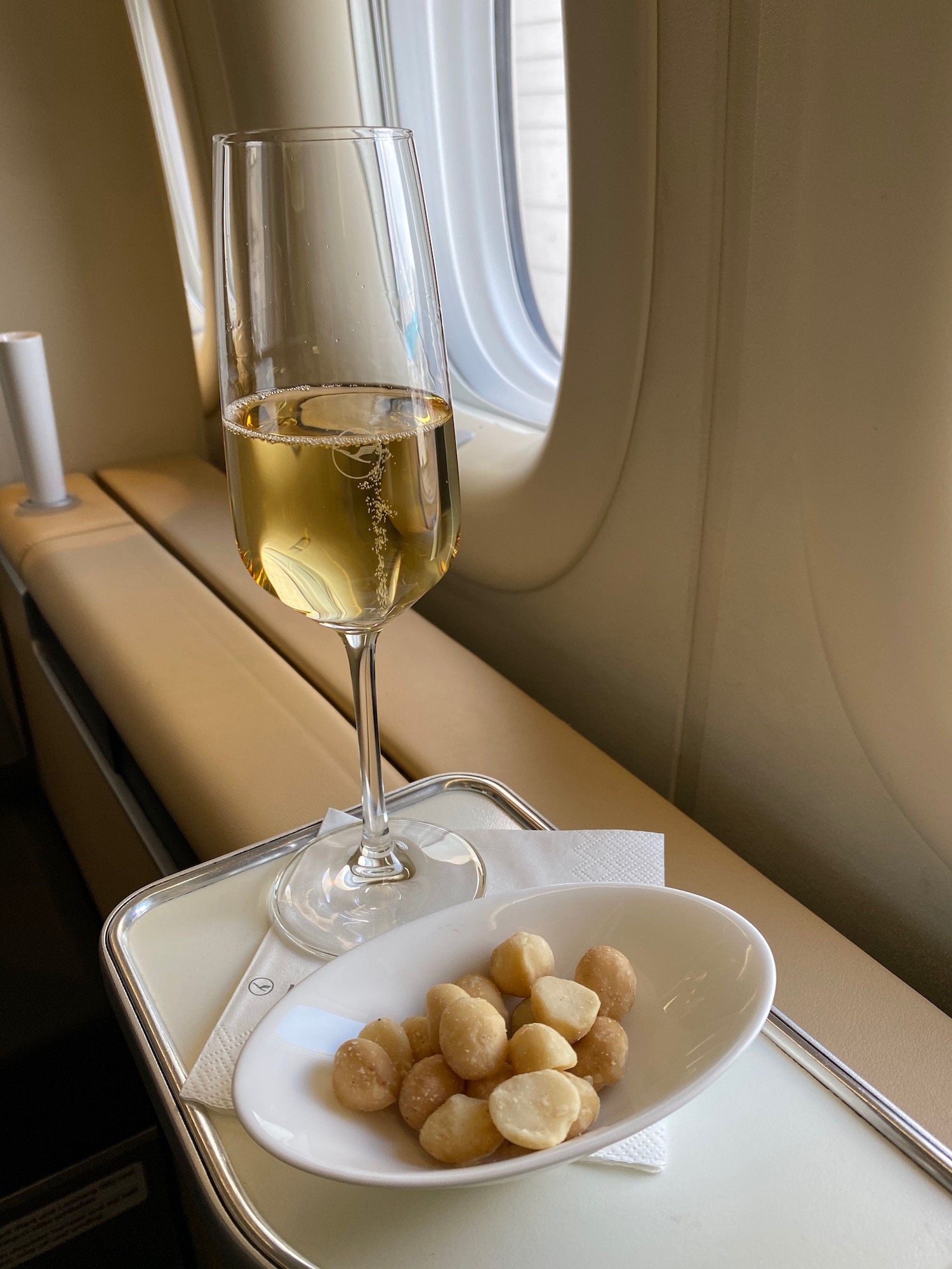 a glass of champagne and food on a plate on a tray