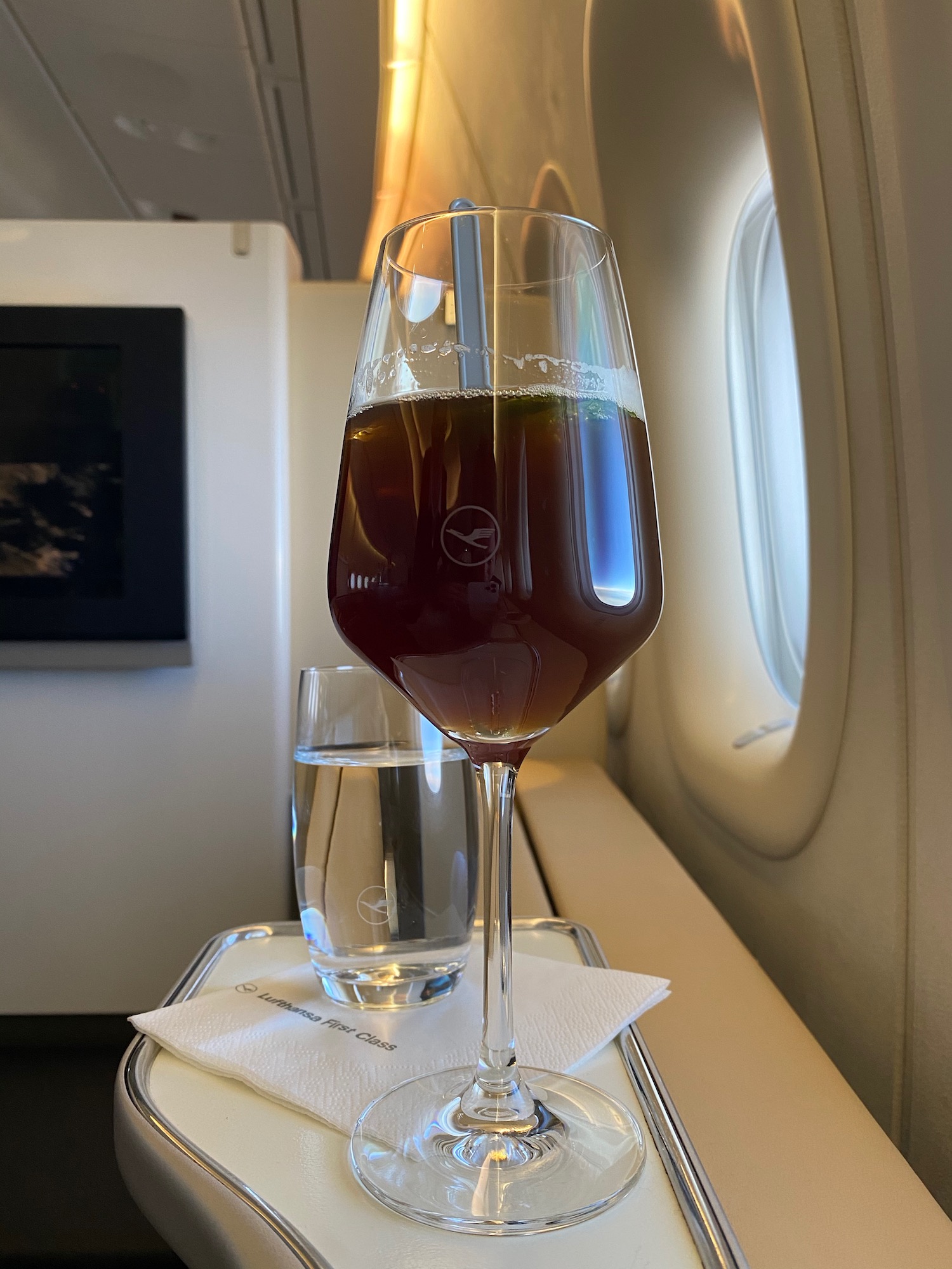 a glass of liquid on a tray