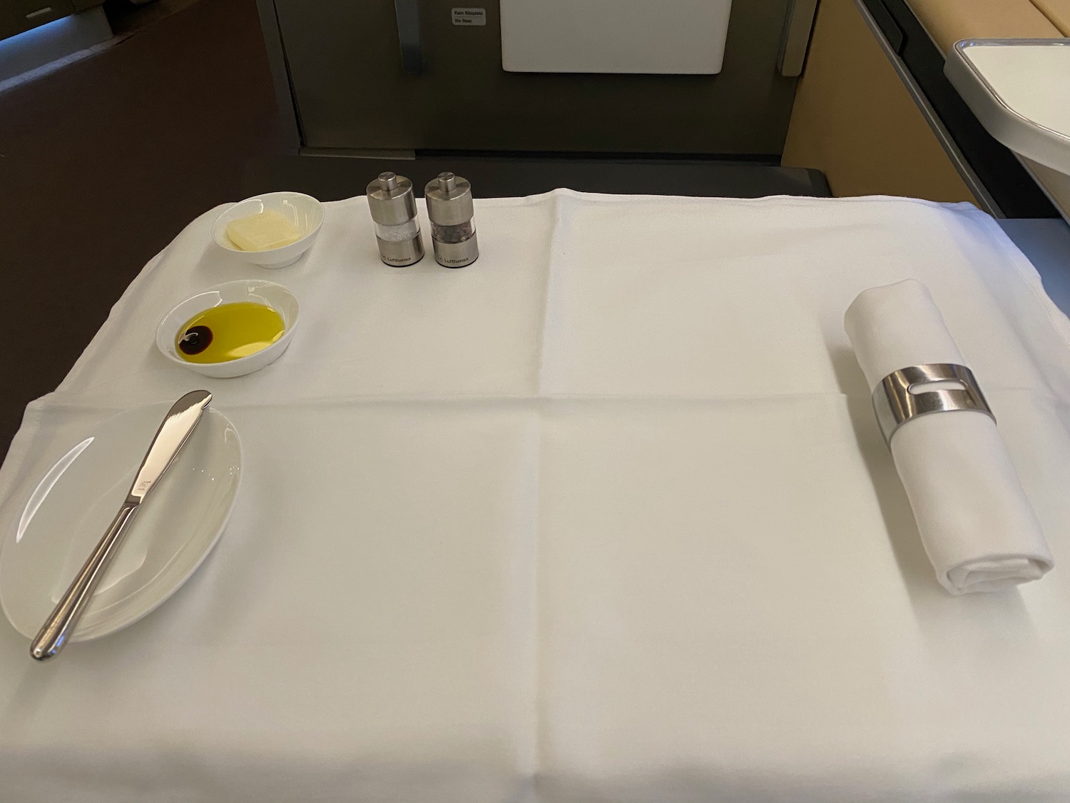 a table with a white tablecloth and a plate with butter and a fork