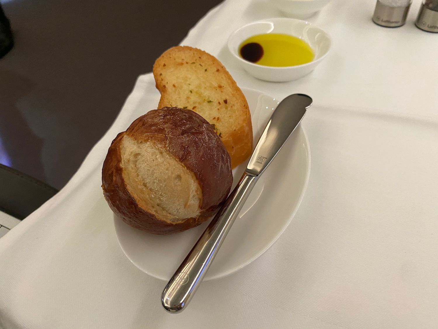 a plate with bread and a knife on it