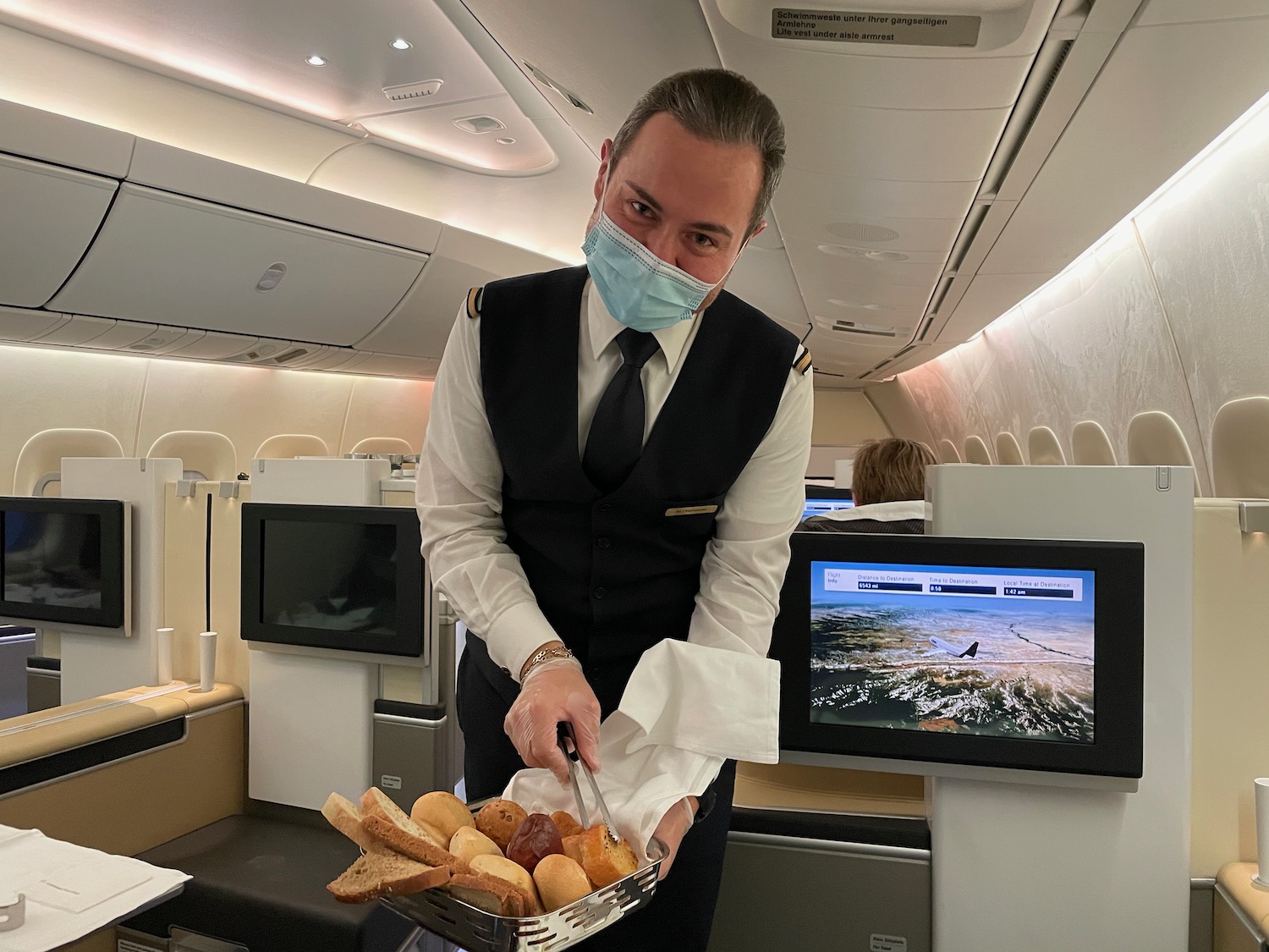 a man wearing a mask holding a tray of food