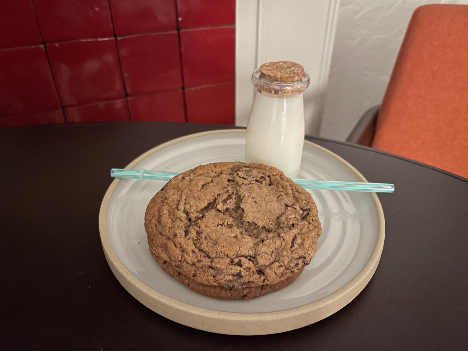 a cookie and milk on a plate