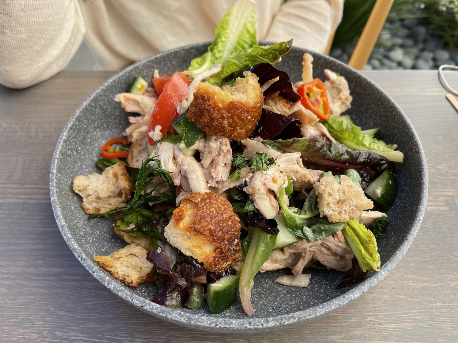 a bowl of salad with meat and vegetables