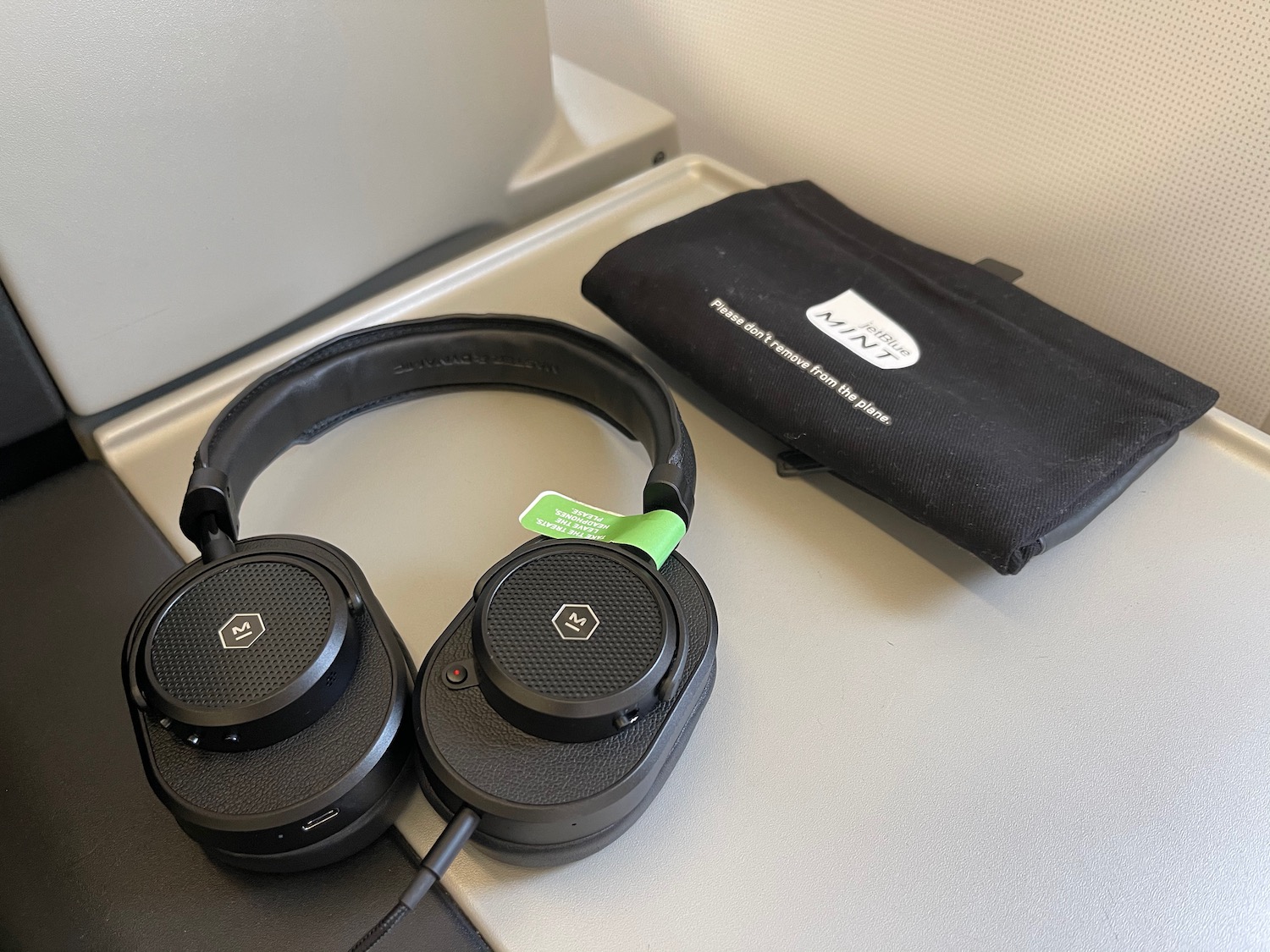 a pair of black headphones on a grey surface